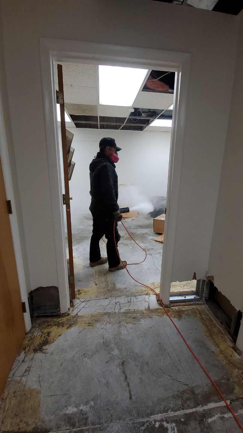 Structural drying equipment positioned throughout affected room during water damage mitigation.