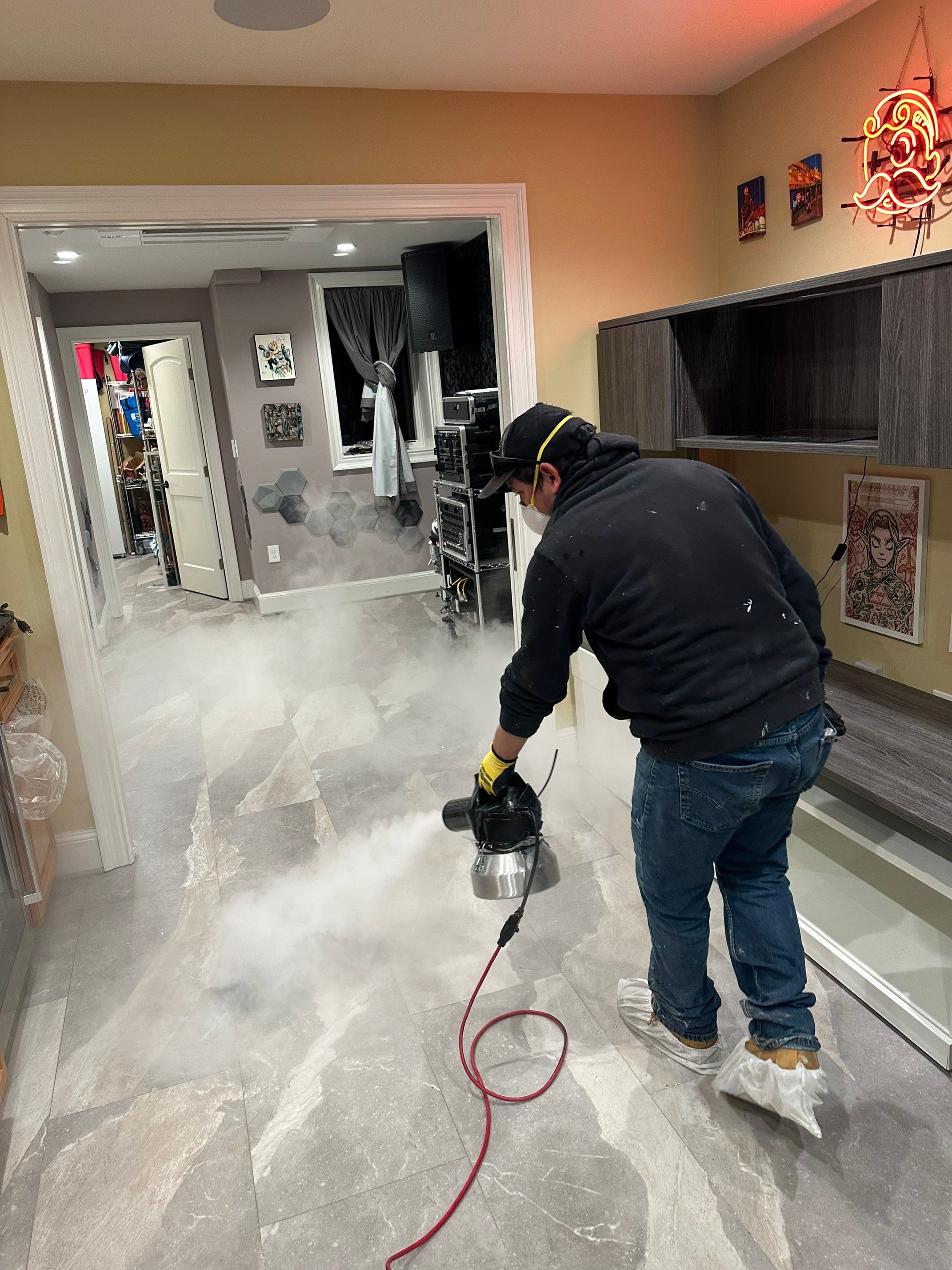 Standing water extraction underway in Washington water damage restoration, dehumidifiers positioned for structural drying.