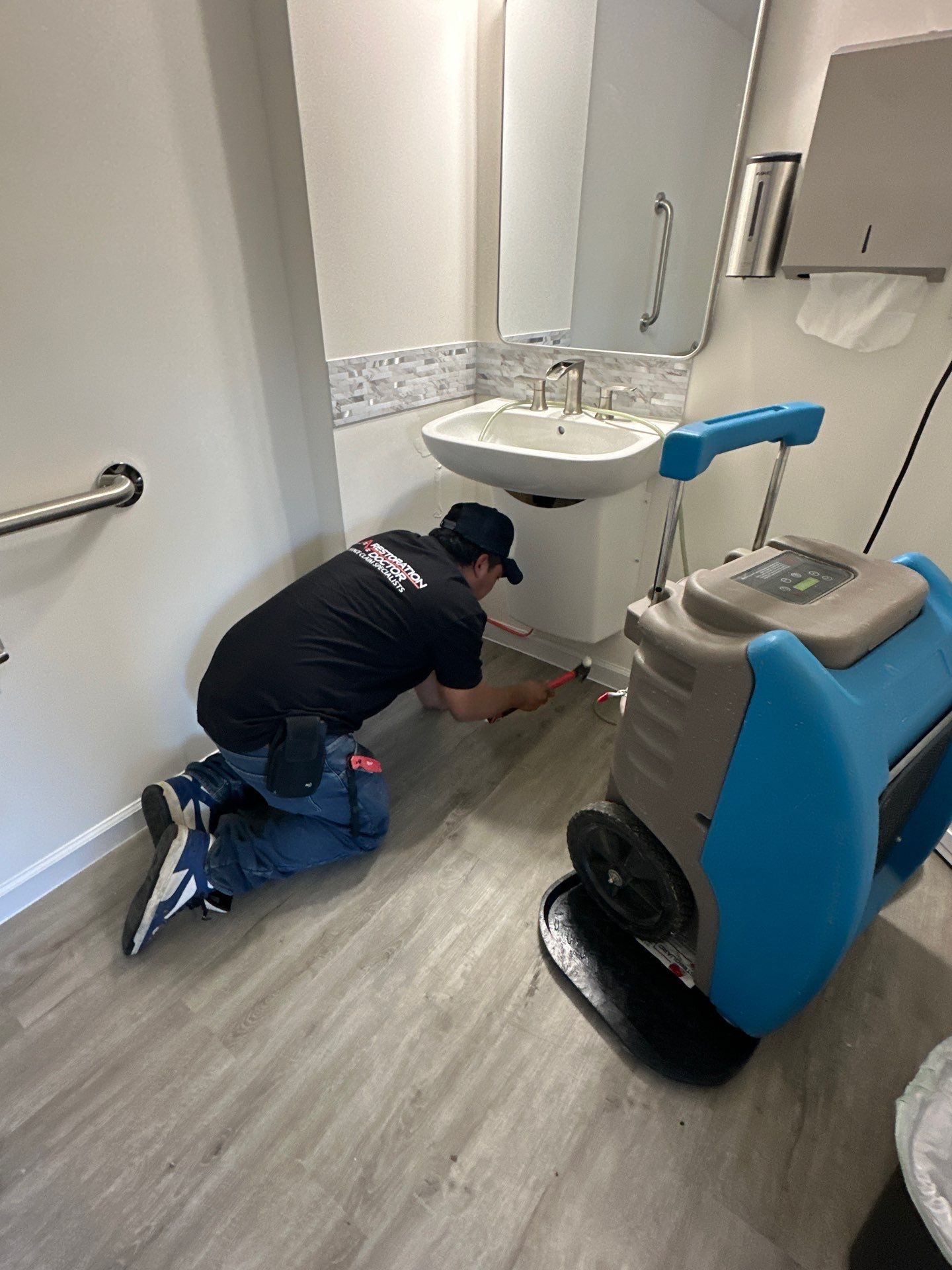 Ceiling damage assessment and preparation for repair during water restoration work.