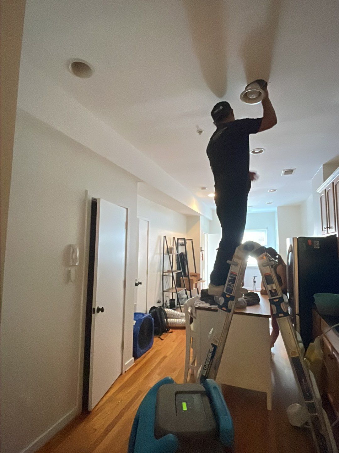 Standing water extraction underway during water damage restoration in Washington, removal equipment deployed.