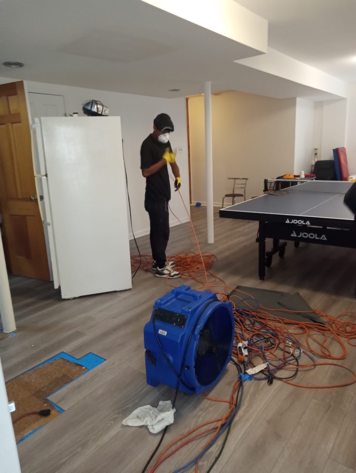 Standing water being extracted from flooded interior during water damage restoration in Washington.