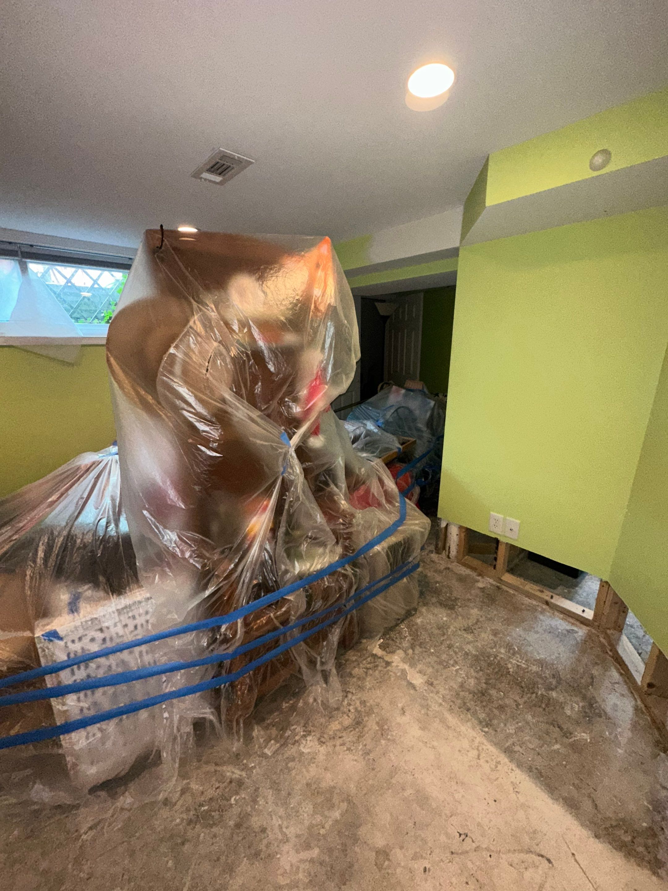 Dehumidifiers and air movers operating during water removal and drying phase.