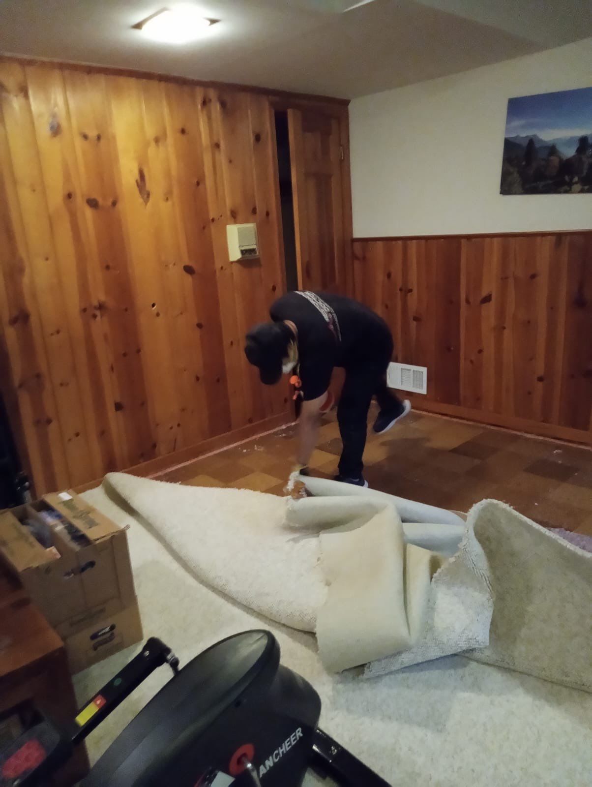 Wet carpet and flooring materials staged for removal during restoration process.