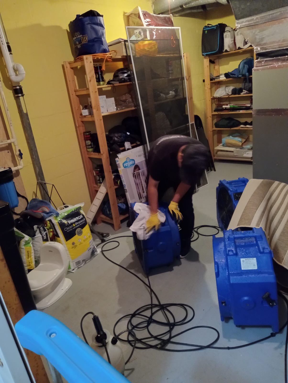 Dehumidifiers and air movers running to dry structural components in Washington home.