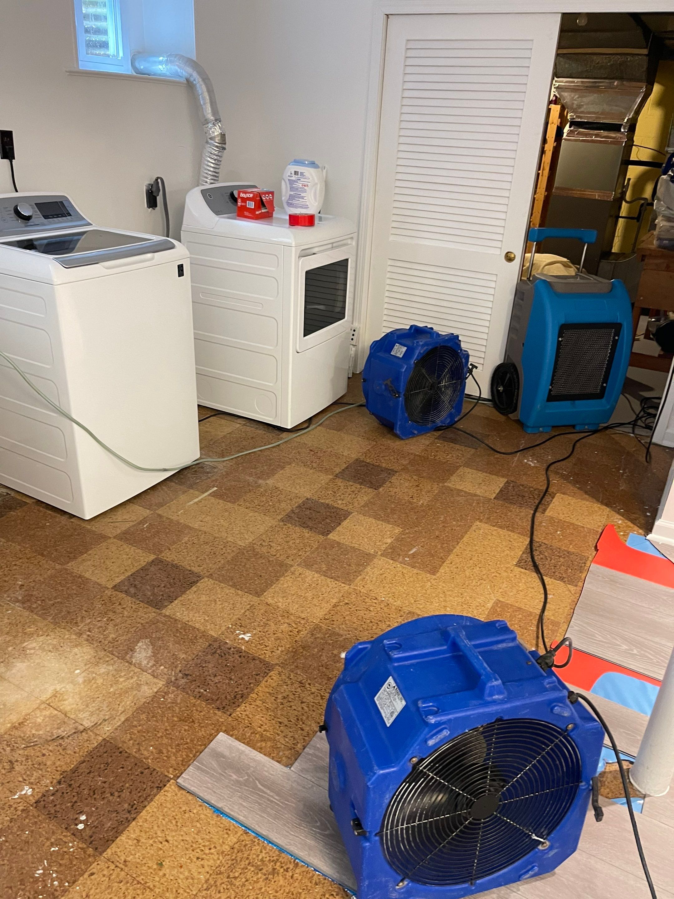 Standing water being extracted from flooded interior during Washington water damage restoration.