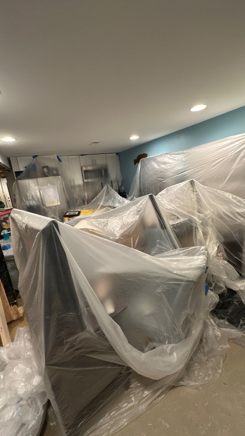 Ceiling damage assessment during water restoration, showing extent of saturation before repair work begins.
