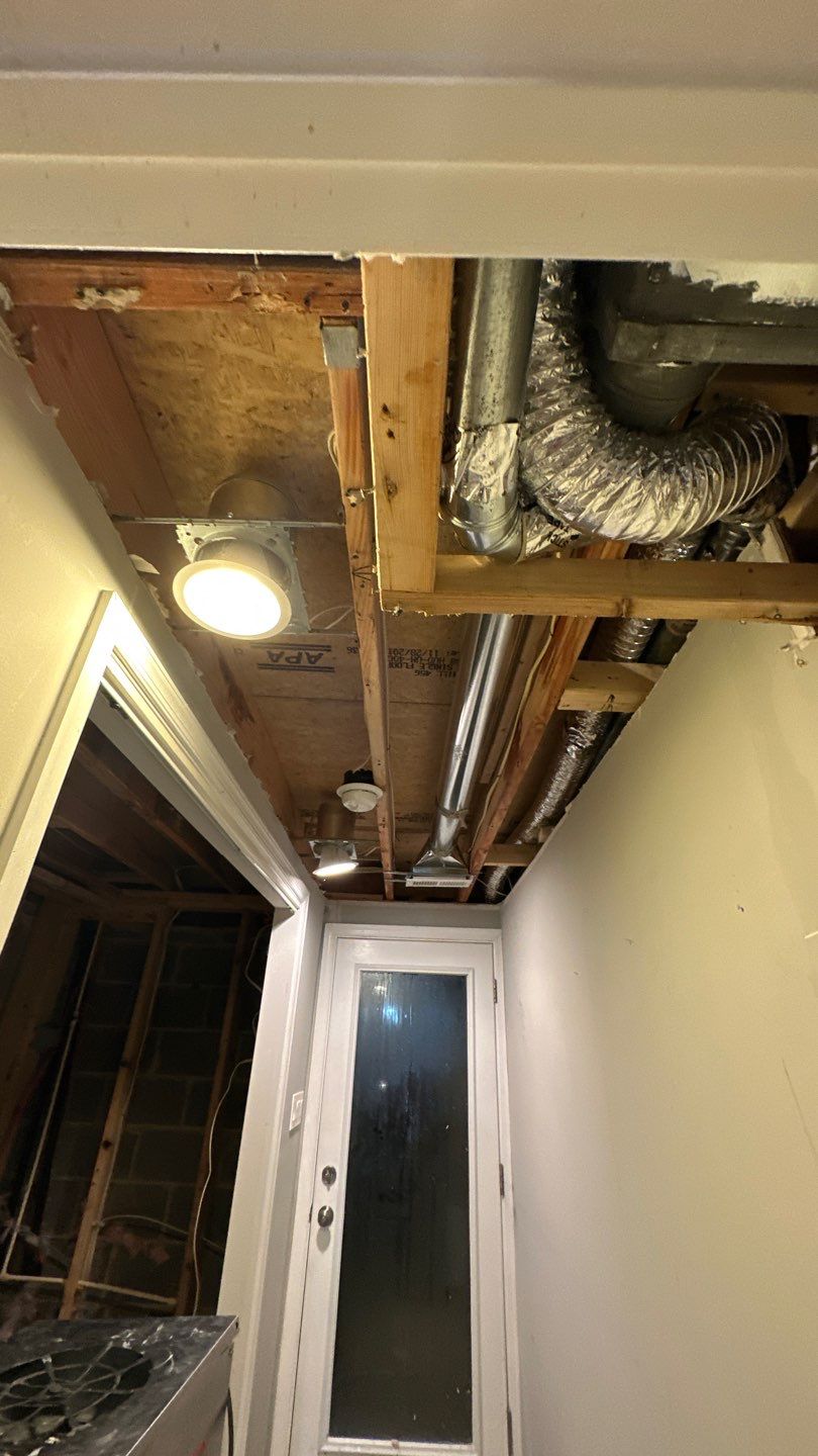 Structural drying in progress with dehumidification equipment positioned to manage moisture in walls and framing.