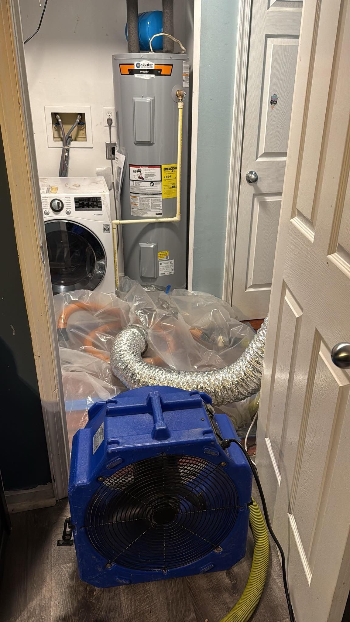 Mid-stage drying operation showing continued equipment placement and moisture management in Silver Spring restoration.