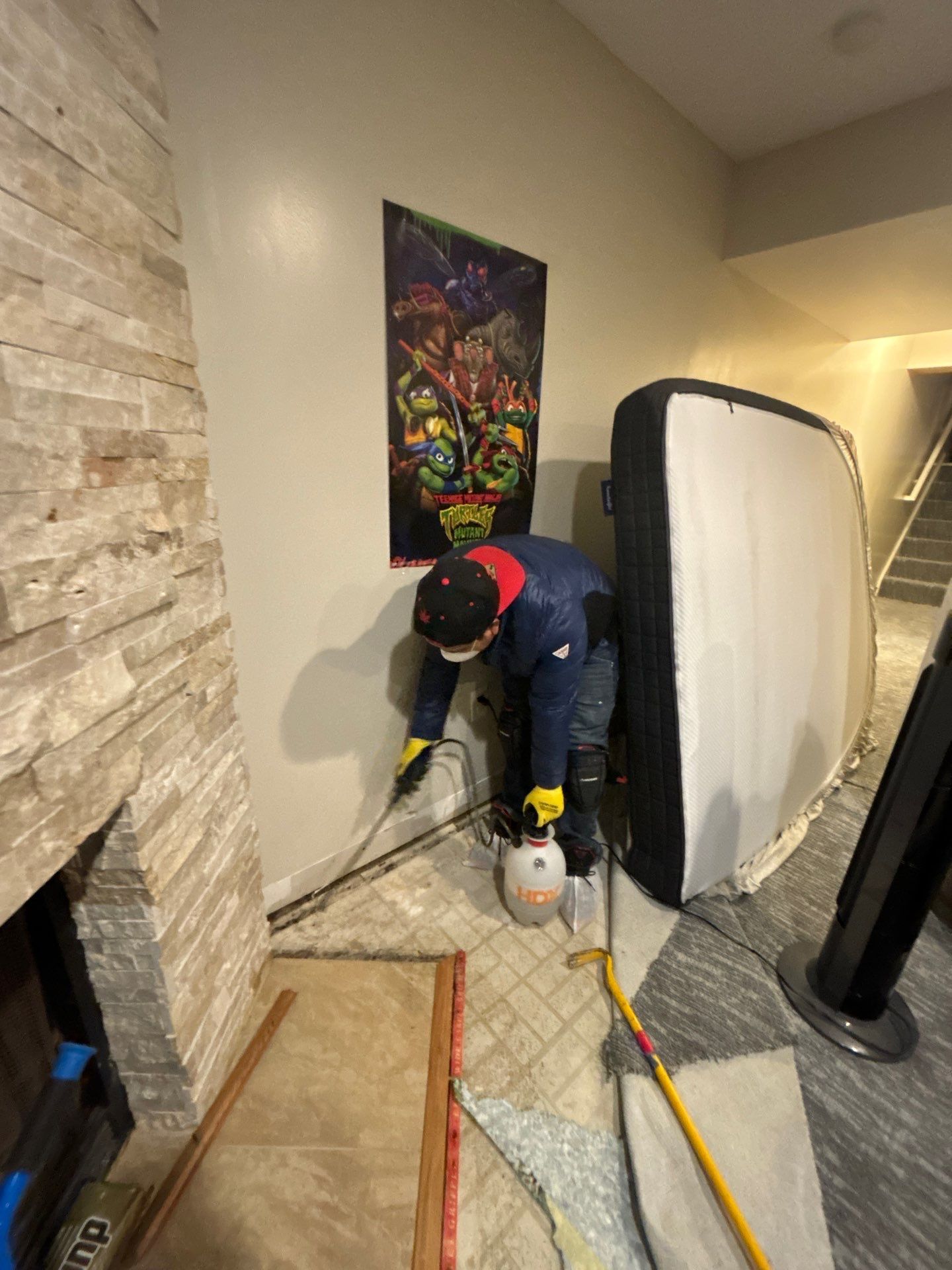 Standing water extraction underway in Silver Spring water damage restoration, removal equipment positioned on wet flooring.