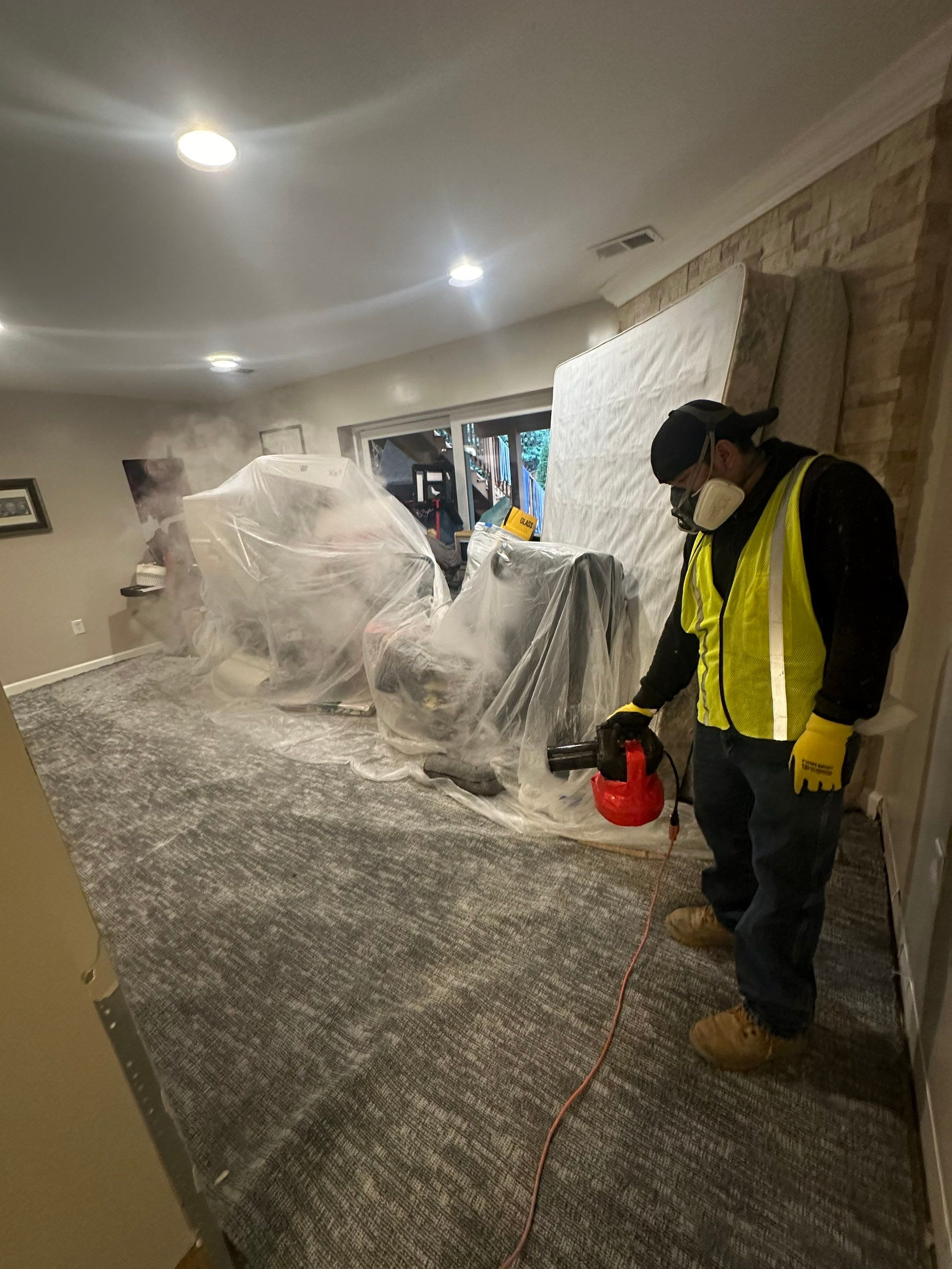 Air movers and dehumidifiers operating during active drying phase of water damage restoration.