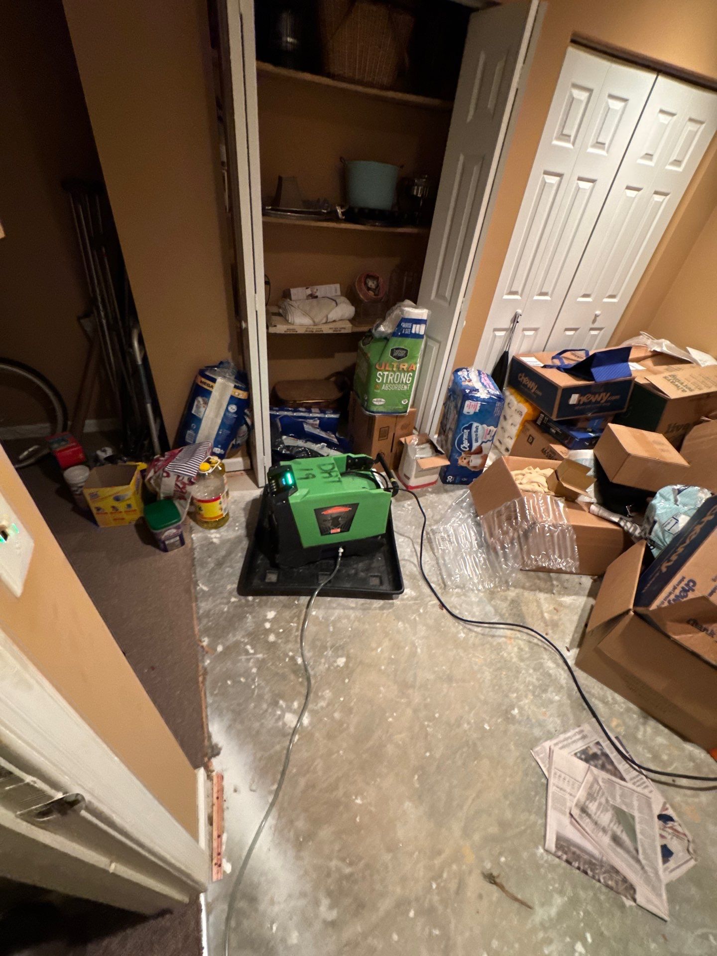 Containment barrier and negative air setup during mold remediation ceiling removal.