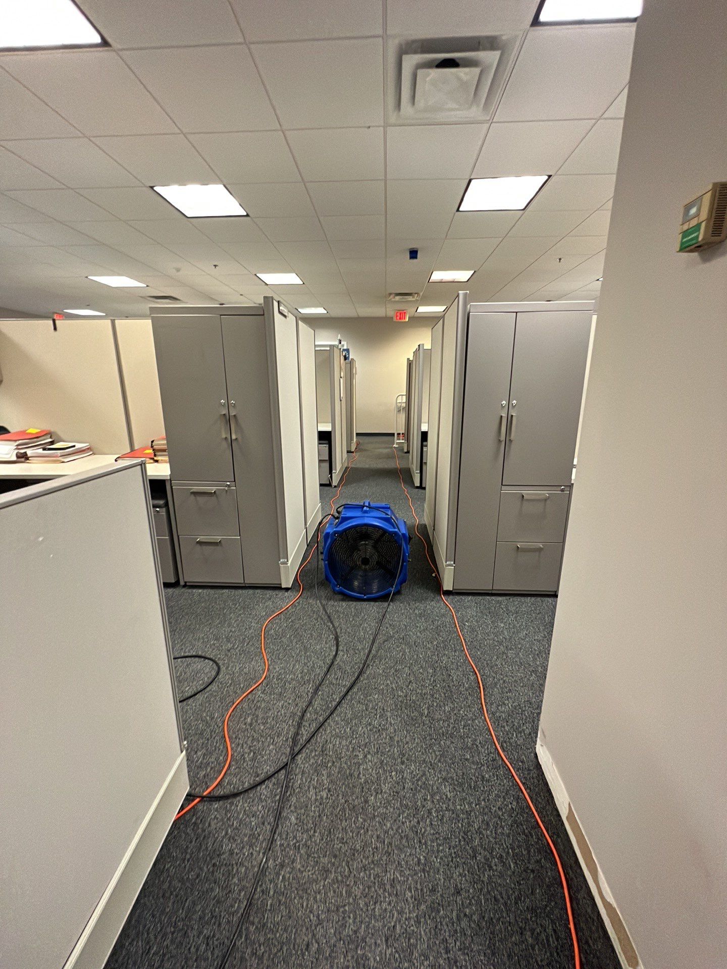 Dehumidification equipment positioned for structural drying after water extraction.
