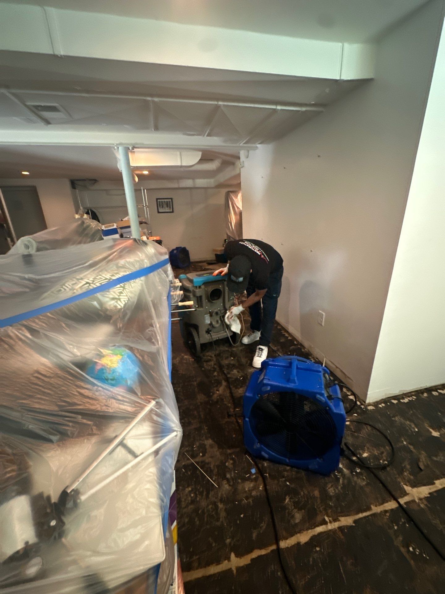 Wet carpet and flooring removed to expose substructure for drying and assessment.