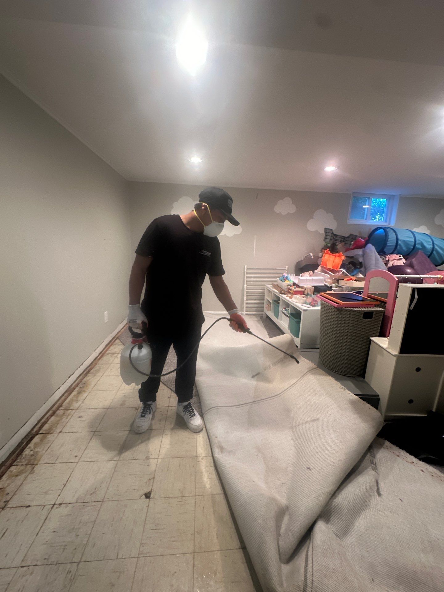 Flooring and carpet removal in progress, exposing substrate for continued drying and assessment.
