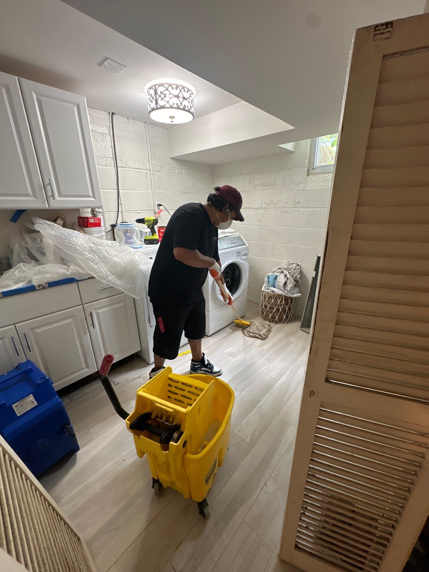 Structural drying equipment positioned throughout affected room during water damage restoration process.