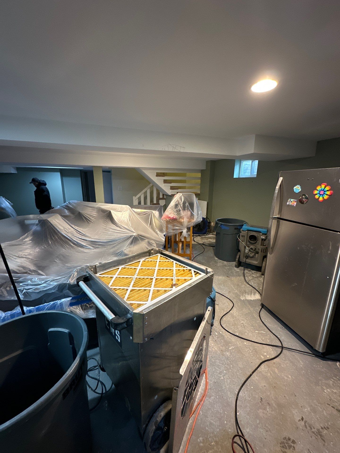 Structural drying equipment positioned throughout affected space during water restoration process.