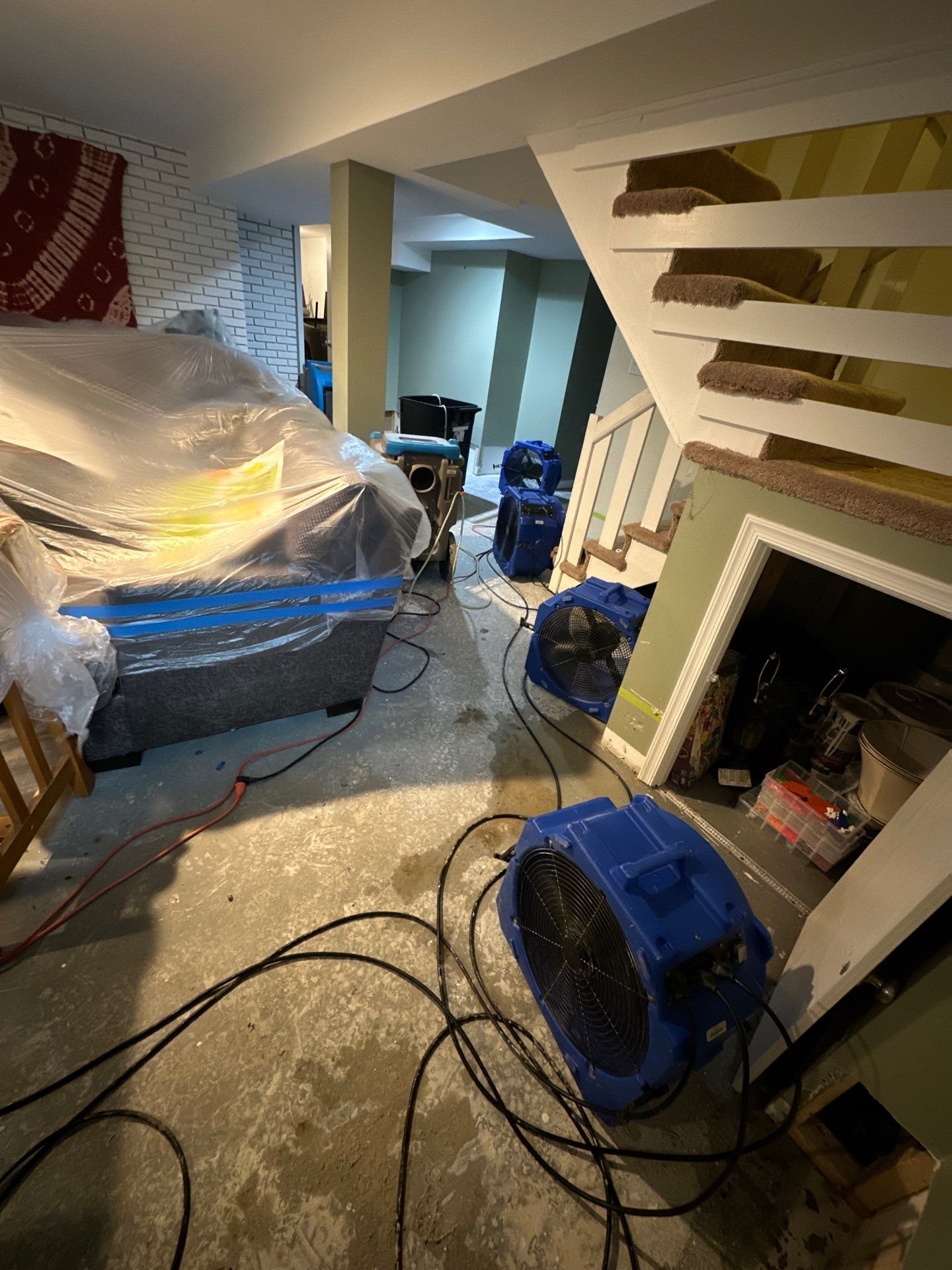Standing water extraction underway in Upper Marlboro water damage restoration, wet flooring visible.