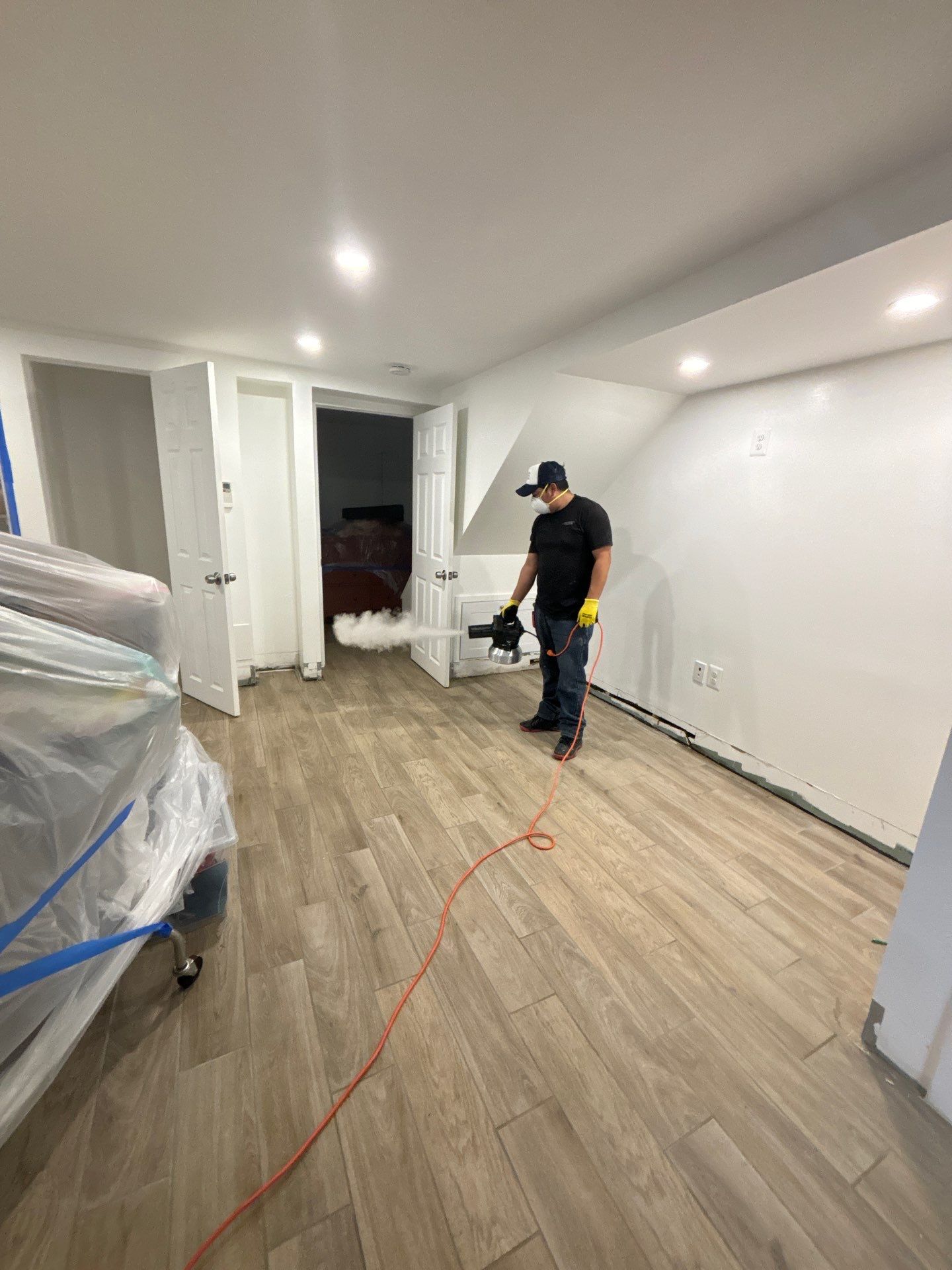 Standing water removal underway in Washington water damage restoration, extractors deployed across affected floor.