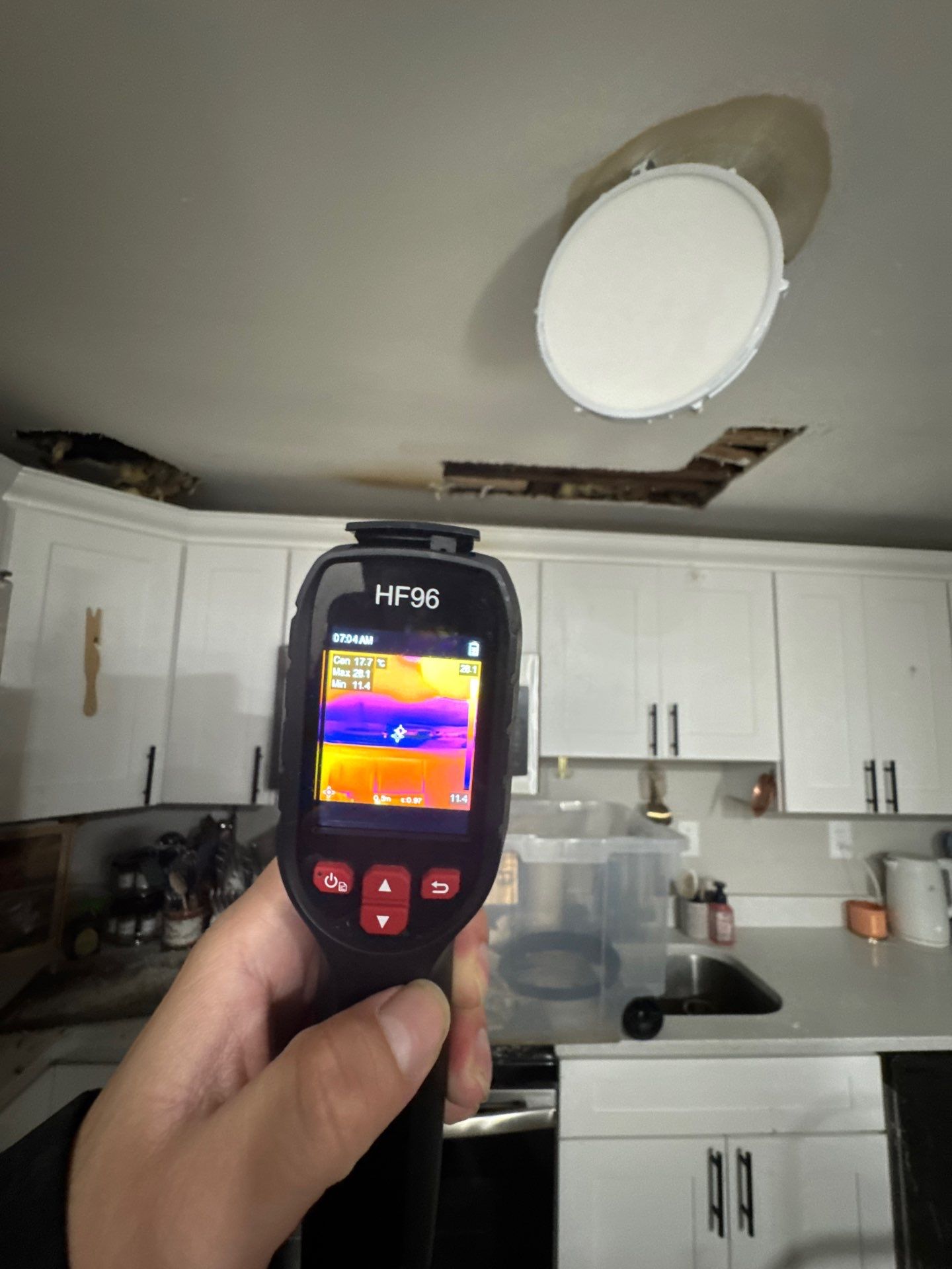 Structural drying equipment positioned to remove residual moisture from affected ceiling cavity.