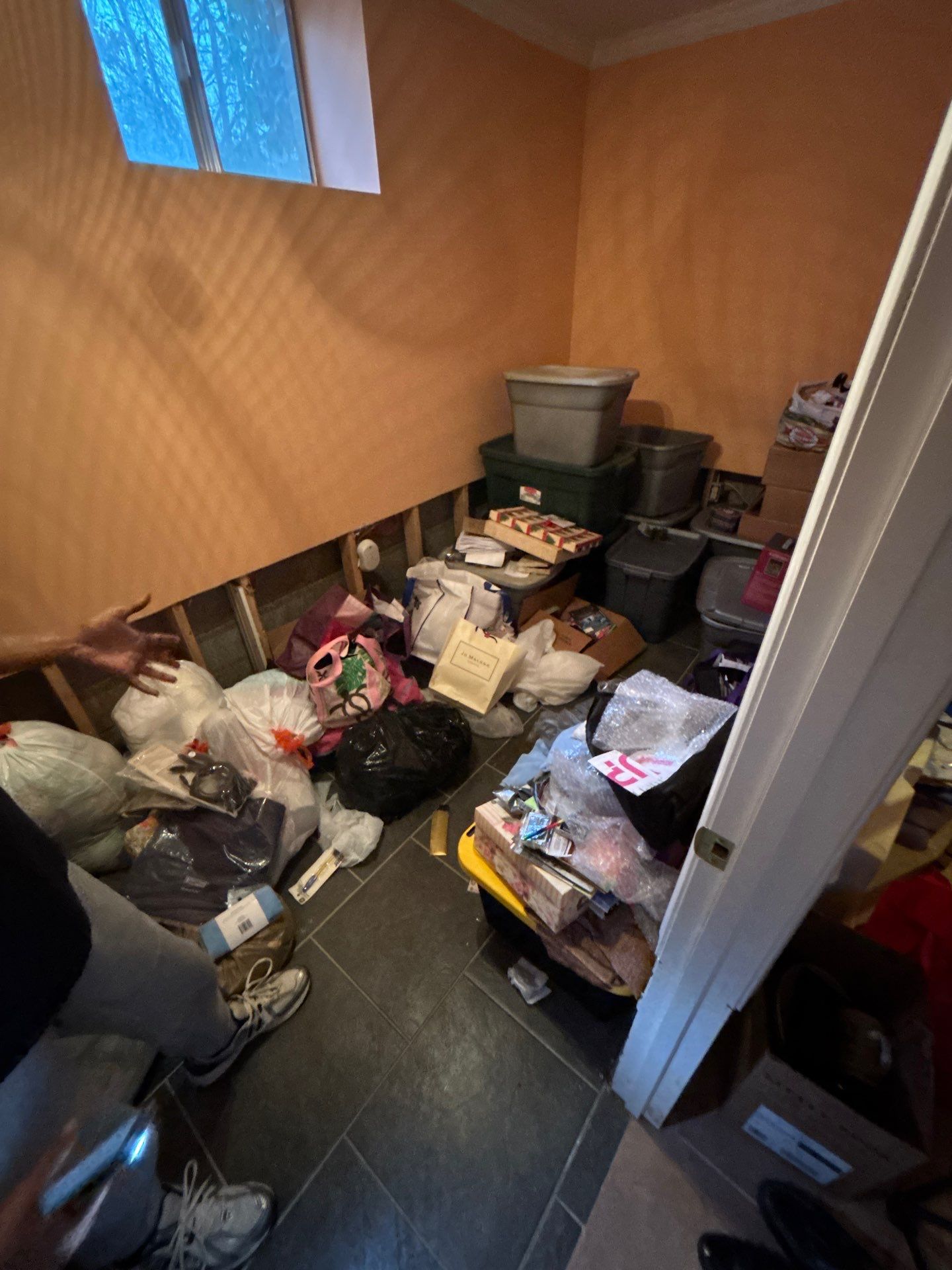 Water damage restoration in Washington: wet drywall and flooring with drying equipment positioned for structural moisture removal.