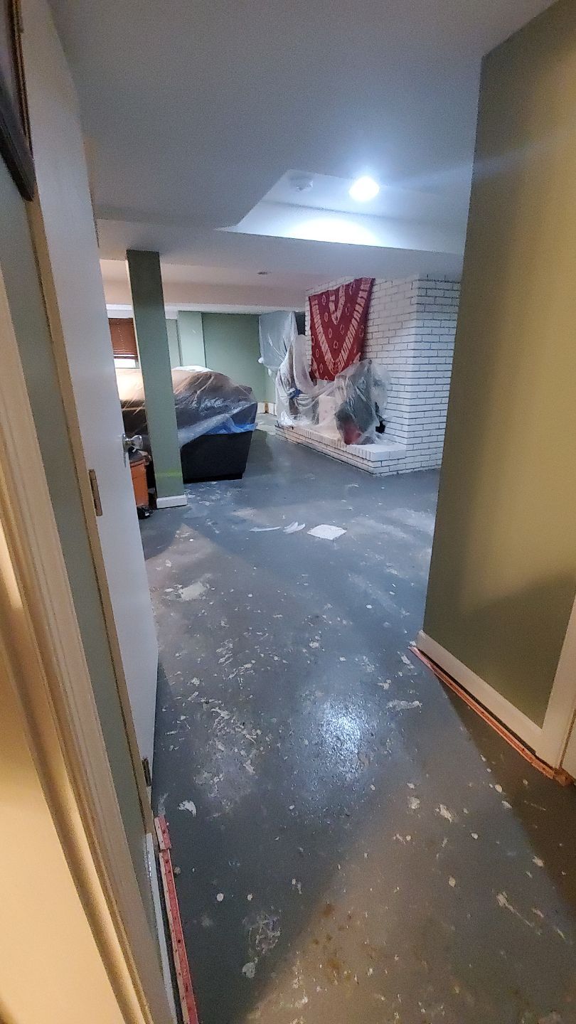 Standing water extraction underway in Marlboro water damage restoration, wet flooring visible.