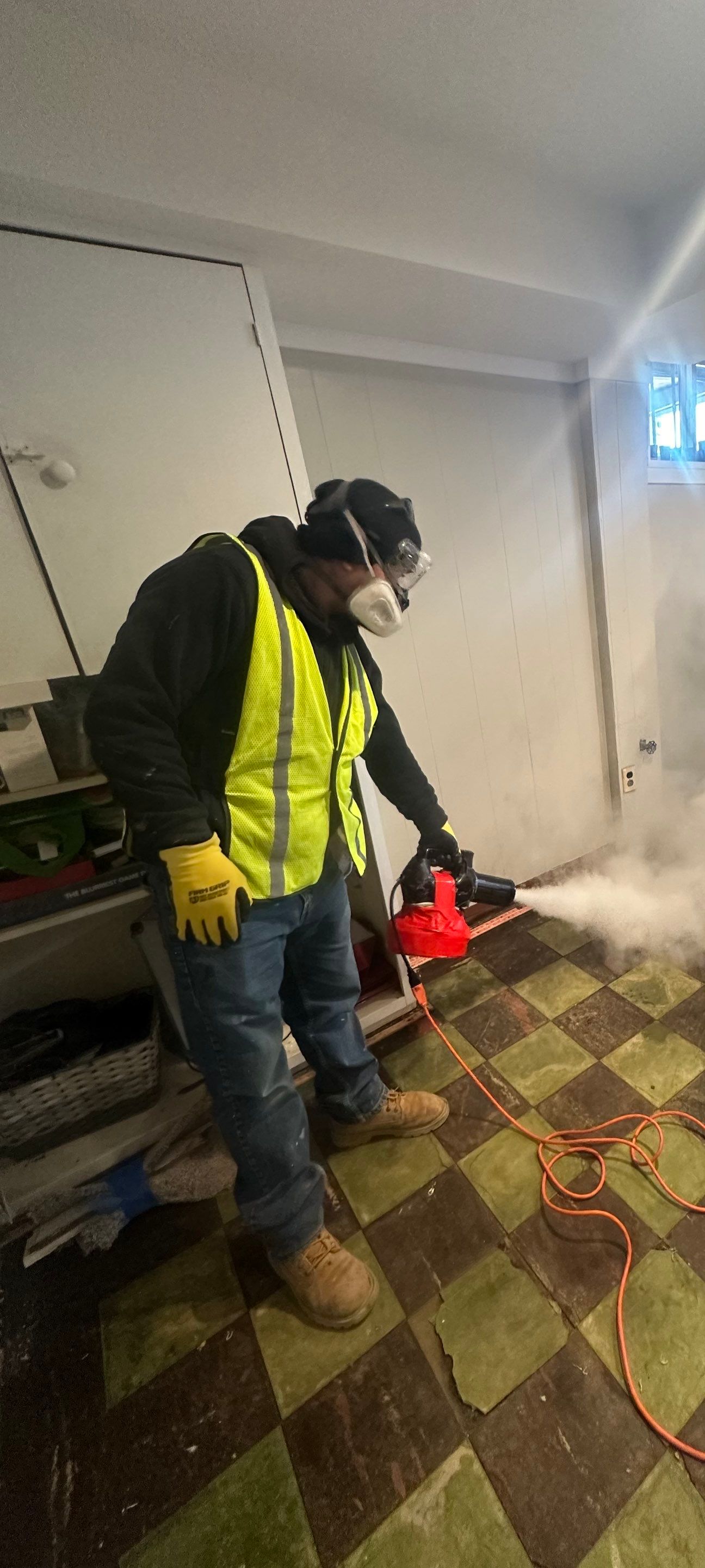 Standing water extraction underway in Washington water damage restoration, dehumidifiers positioned for structural drying.