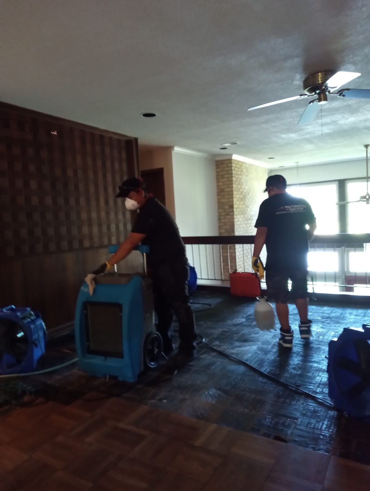 Standing water extraction underway in Fort Washington water damage restoration, wet flooring visible.