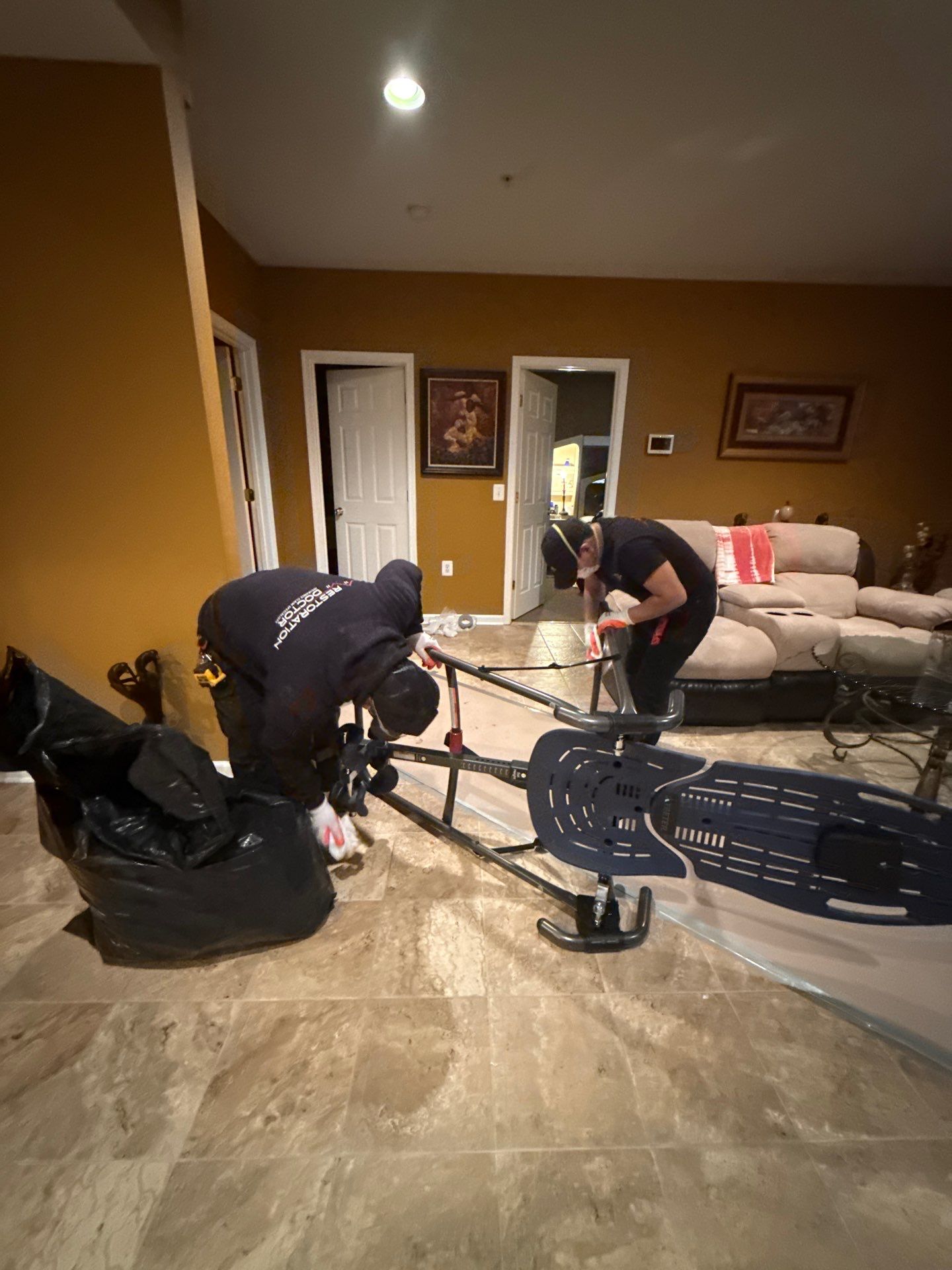 Flooring removal and moisture mapping in progress at Bowie water damage restoration site.