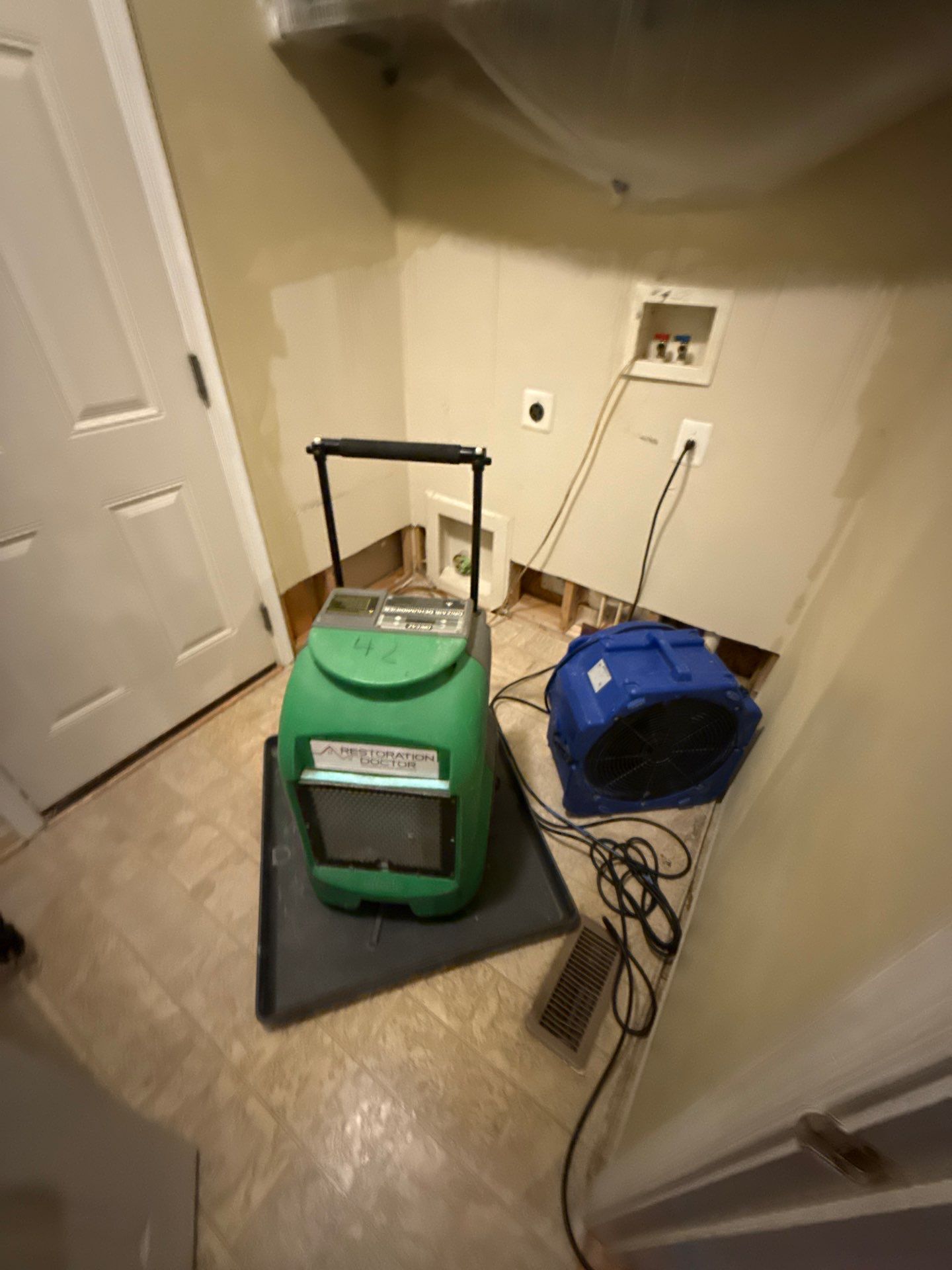 Structural drying equipment deployed across affected interior spaces during water damage restoration.