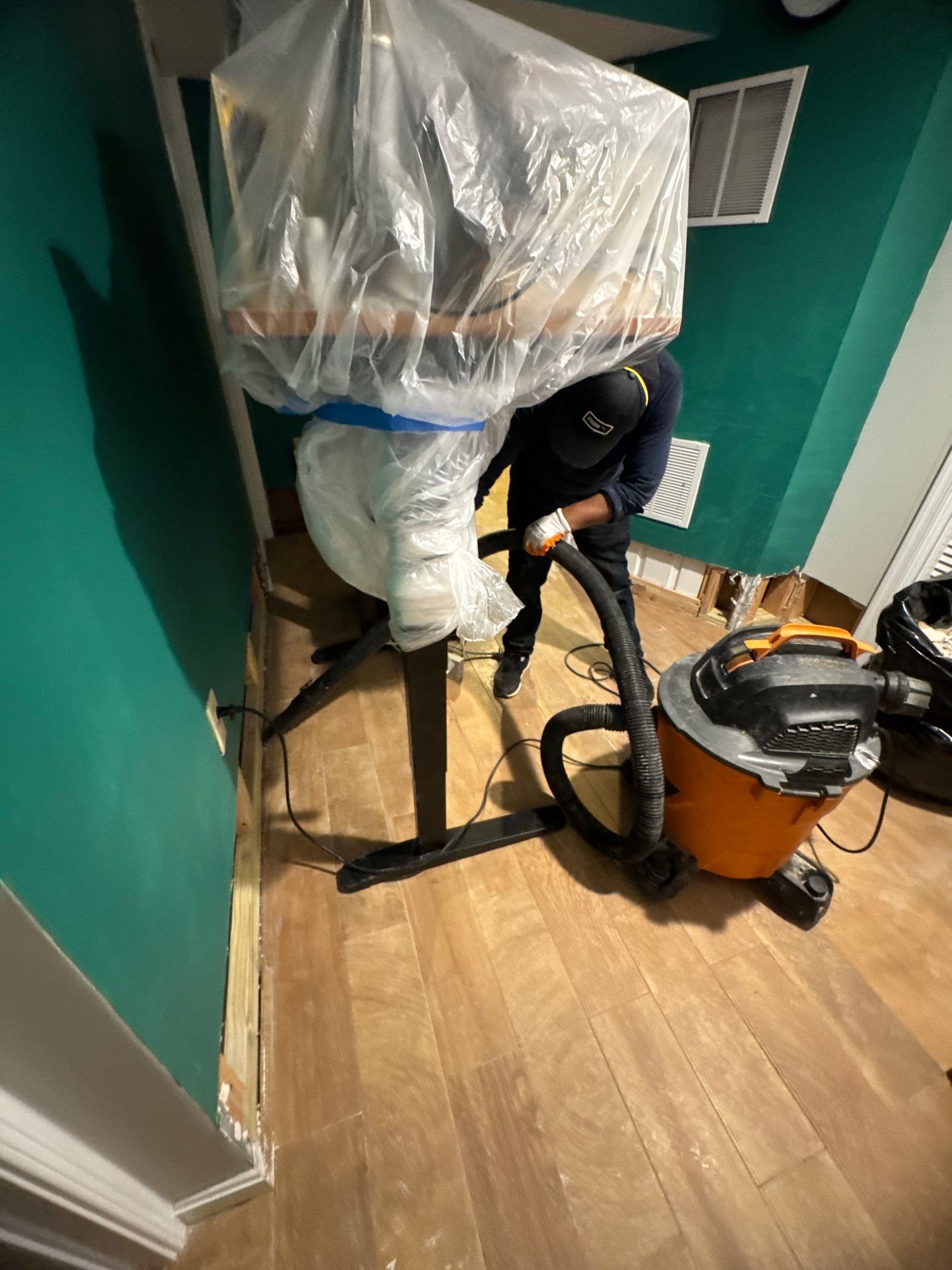 Drying process in progress, dehumidification and air movement targeting saturated building materials.