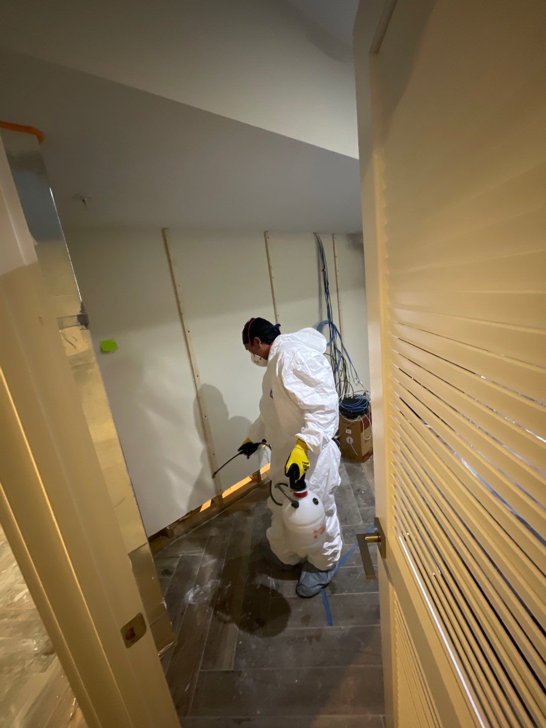Standing water being extracted from flooded interior during Washington water damage restoration.