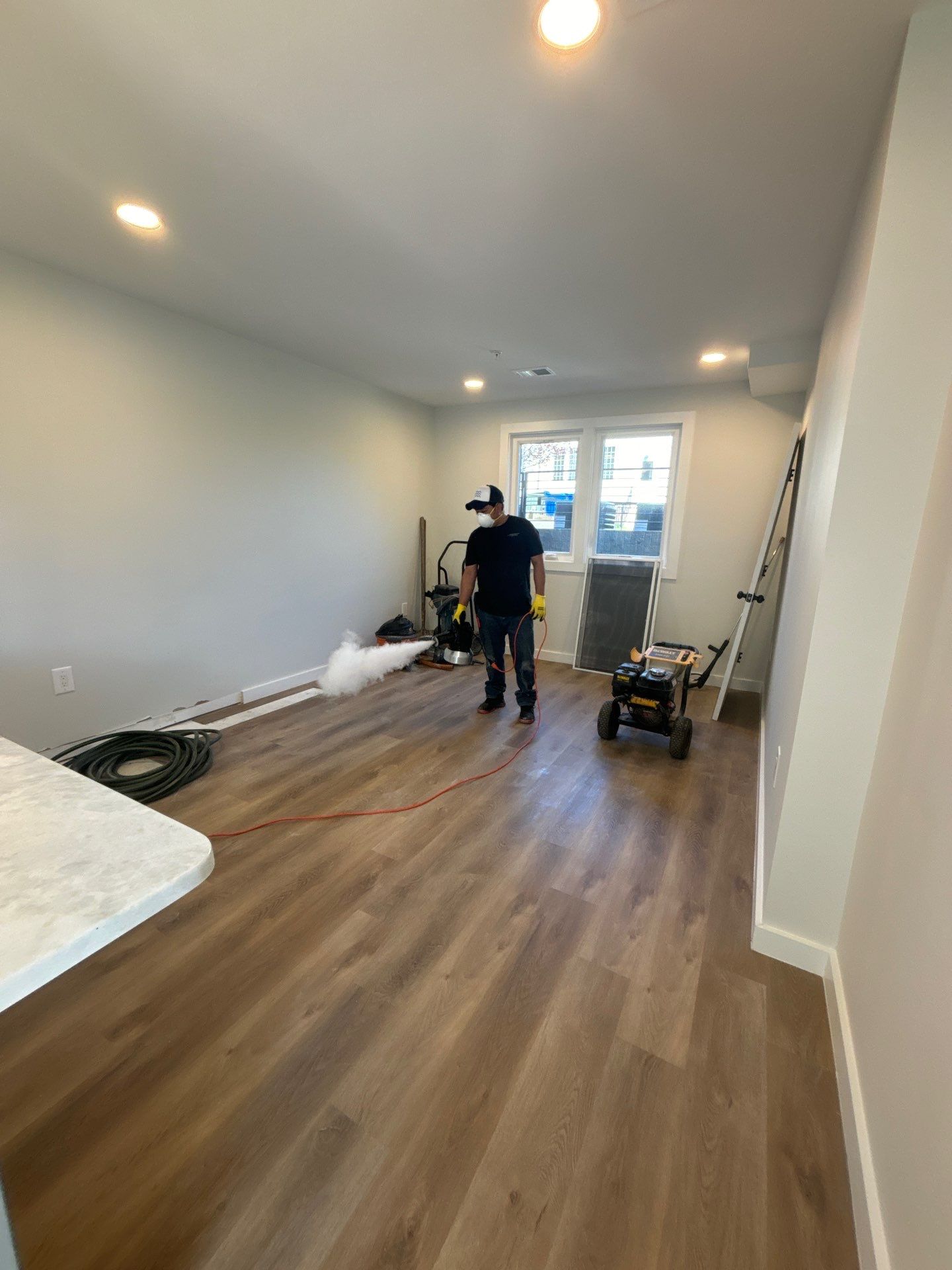 Standing water extraction underway in Washington home during water damage restoration.
