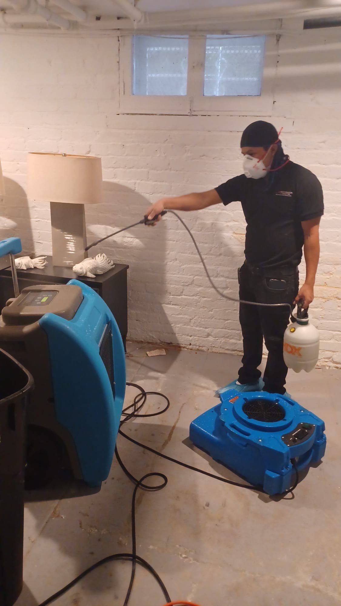 Moisture monitoring and air circulation setup continuing water damage restoration in Washington.