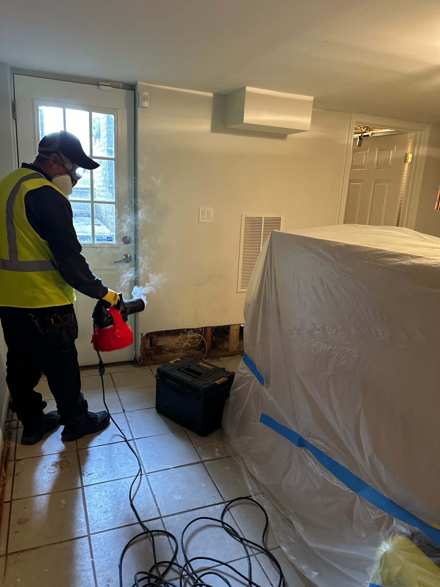 Standing water extraction begins during mold remediation in Washington, removing pooled moisture from affected surfaces.