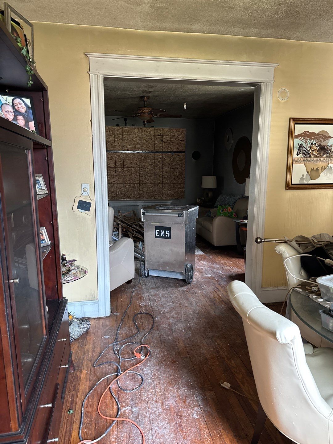 Dehumidifiers and air movers positioned for structural drying after water extraction.