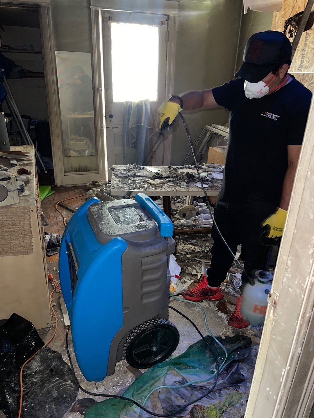 Standing water being extracted from flooring during water damage restoration in Washington.