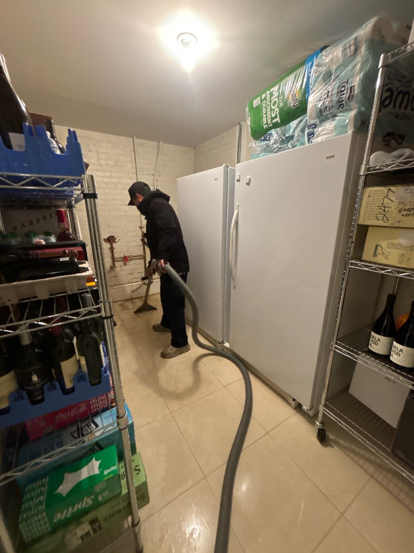 Standing water extraction underway during water damage restoration in Washington, removing pooled water from flooded interior space.