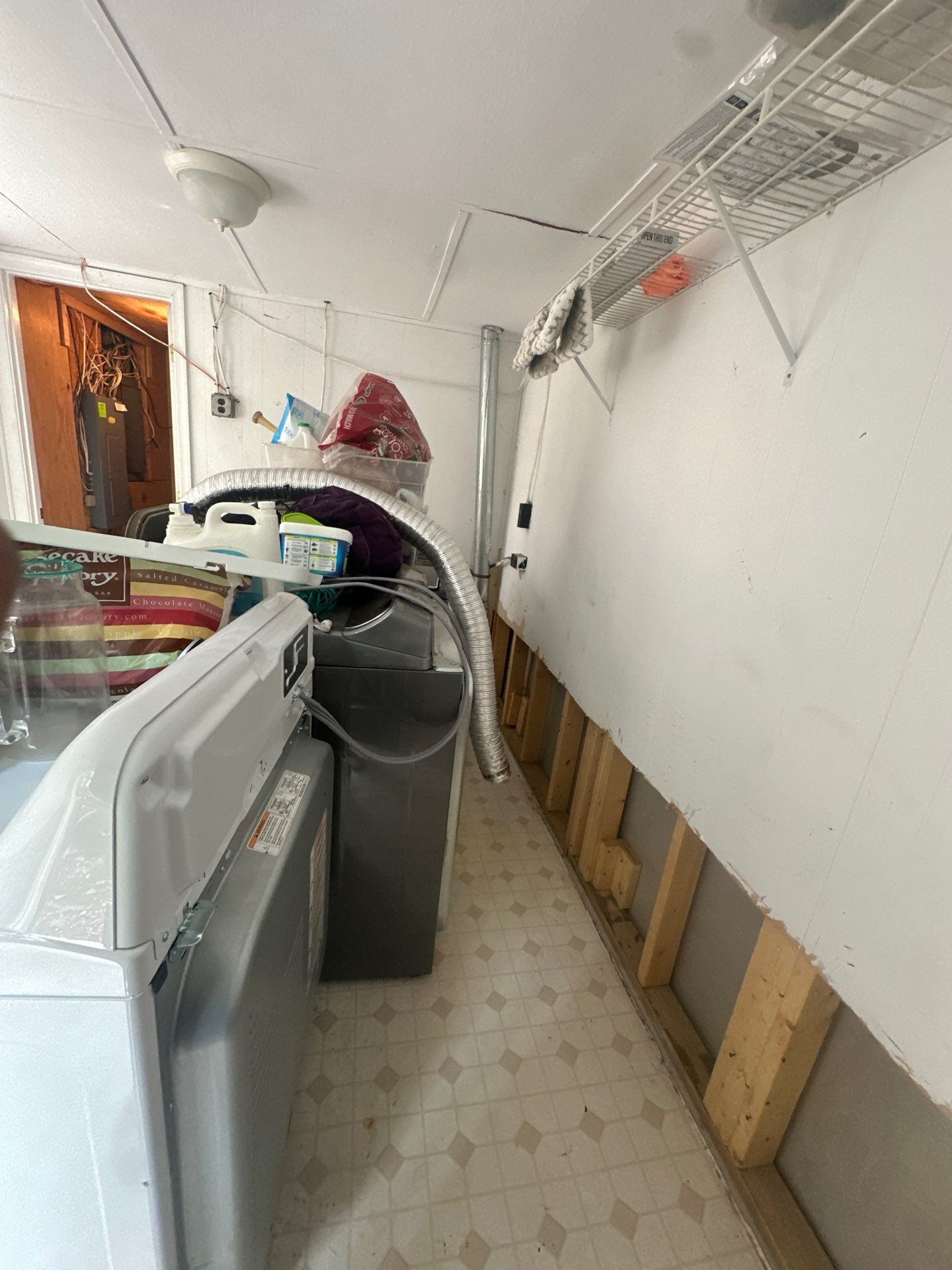 Structural drying in progress with dehumidification units operating to remove moisture from walls and flooring.