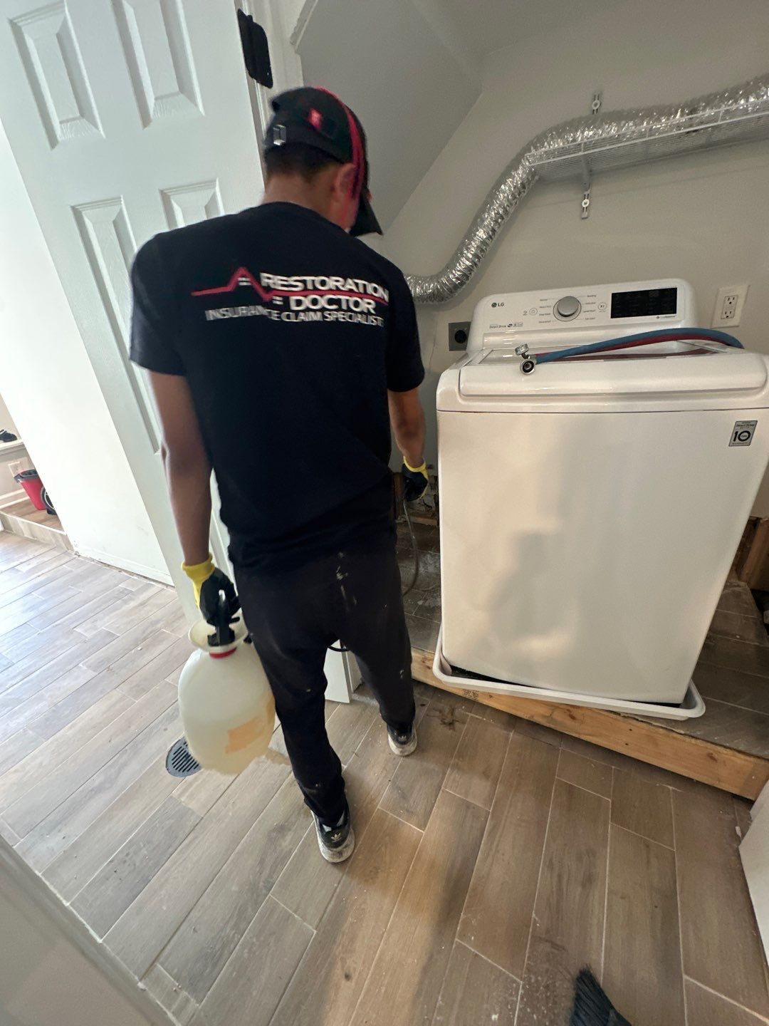 Standing water being extracted from flooded interior during water damage restoration in Washington.