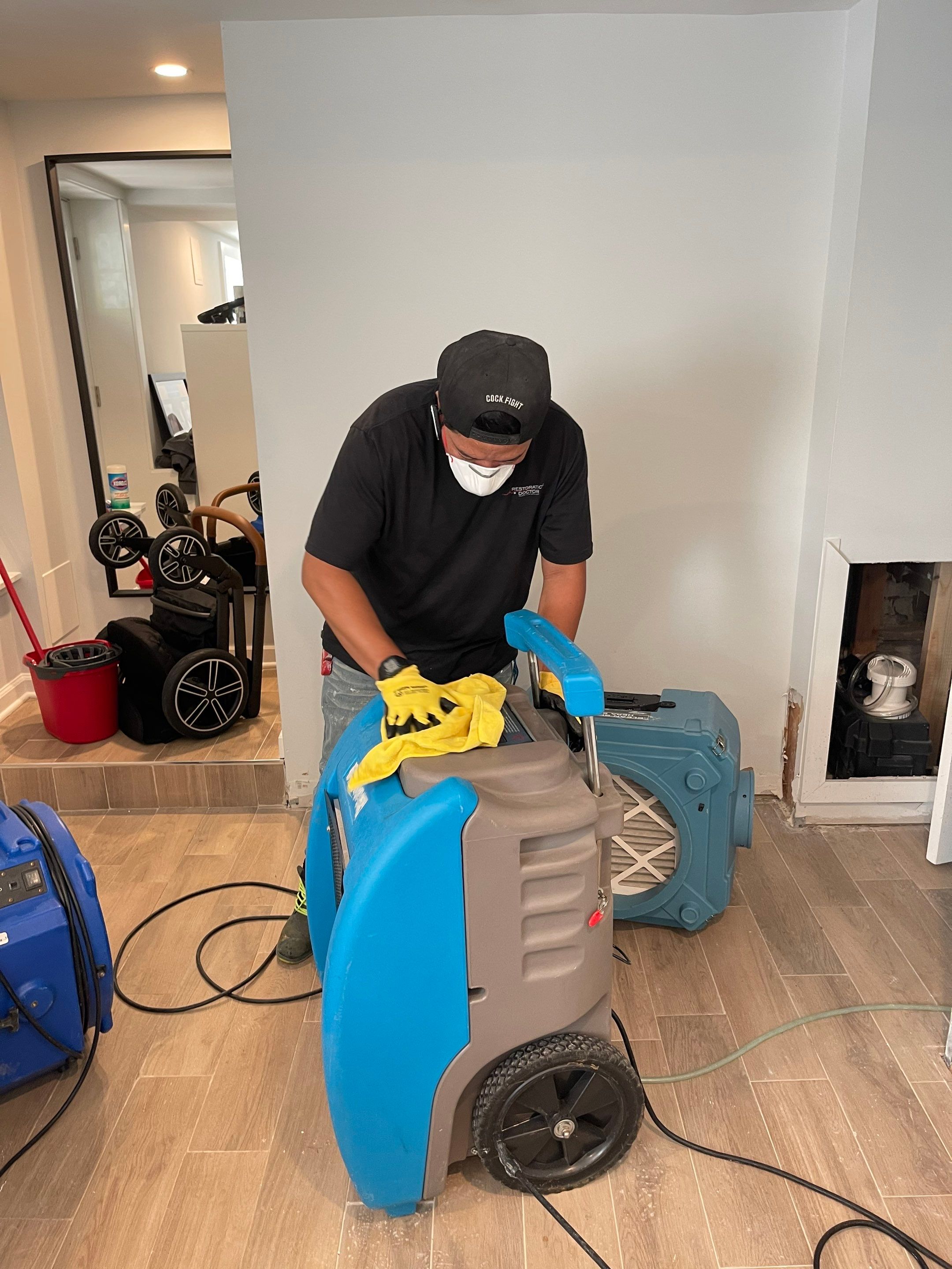 Wet carpet and flooring removed to expose subfloor for drying in Washington water damage job.