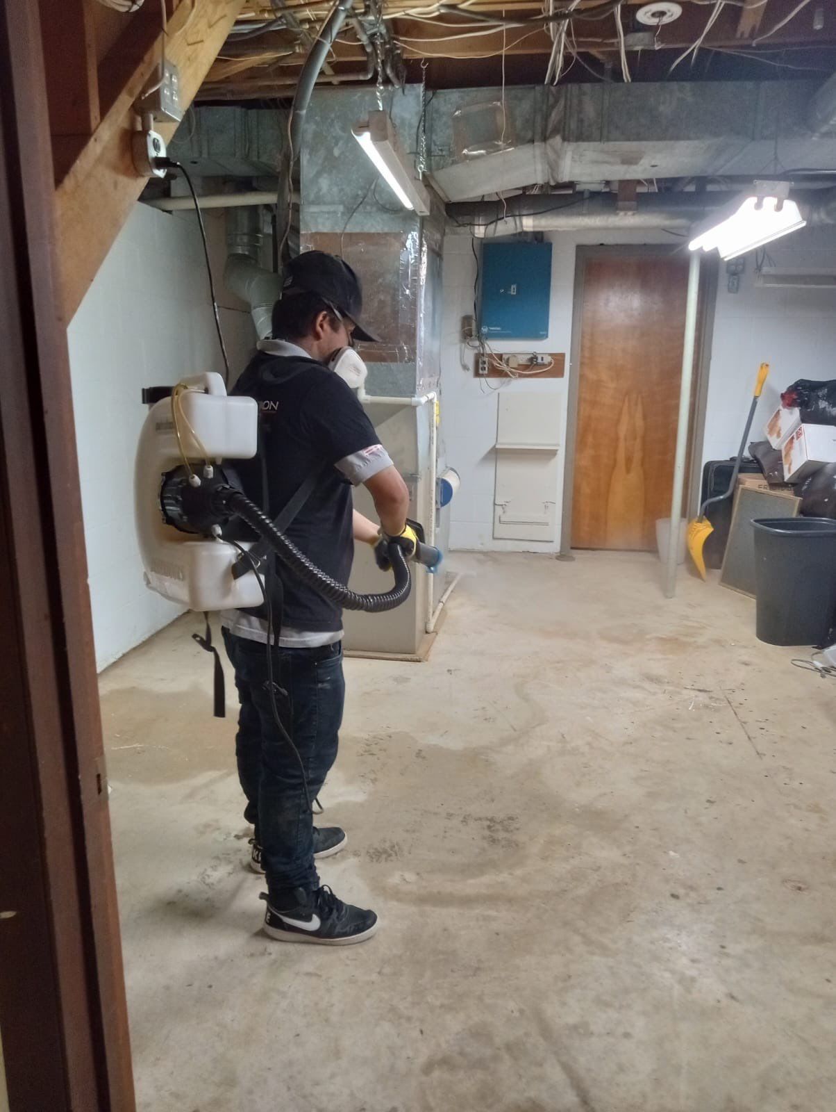 Standing water extraction underway in Kensington water damage restoration, removal equipment deployed across affected floor.