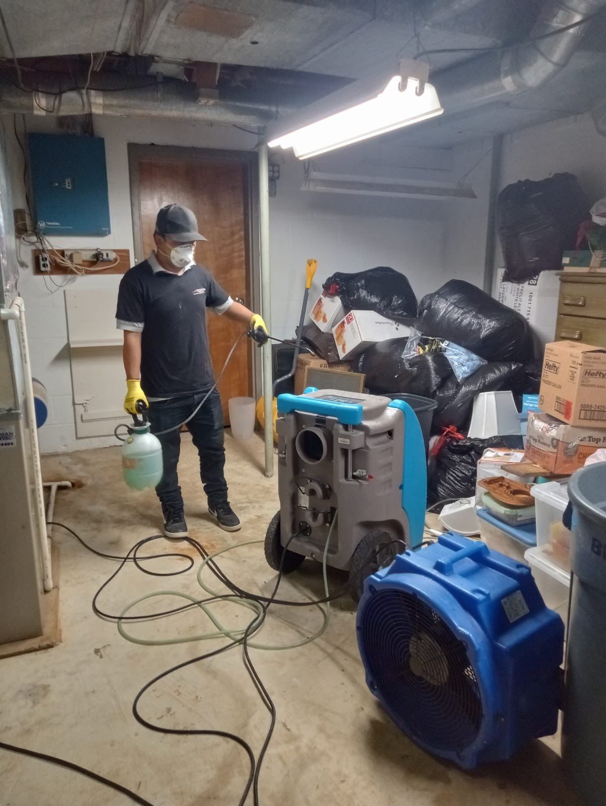 Dehumidification equipment positioned throughout interior space during mid-stage drying phase of water restoration.